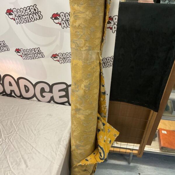 Roll of gold woven furniture fabric with blue-grey floral pattern