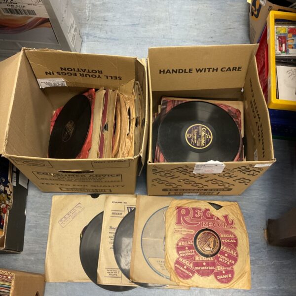 Vintage gramophone records in cardboard boxes, a collectible lot.