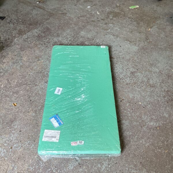 Green roll of flooring underlay for sound and impact protection.
