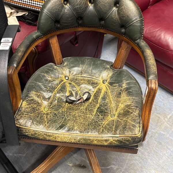 Green buttoned leather captain's armchair with wooden frame and swivel base