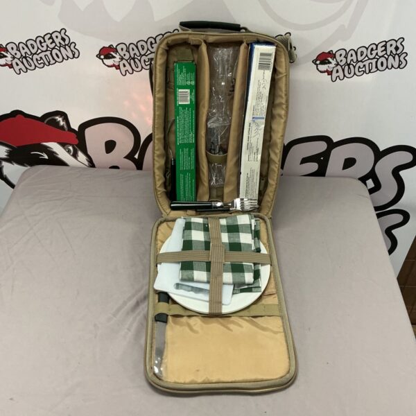 Vintage green picnic basket set with contents for outdoor dining.