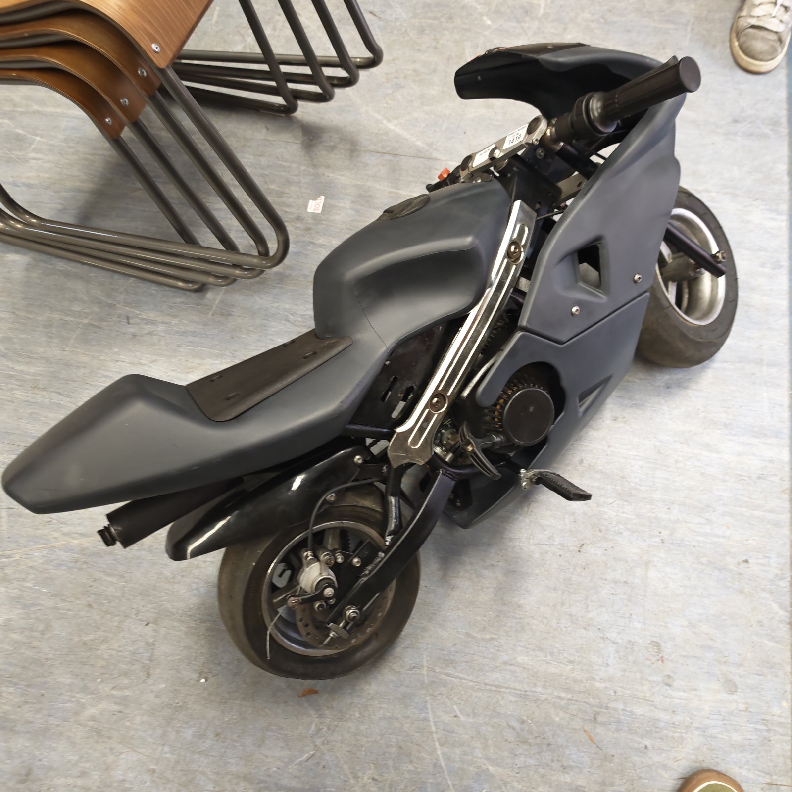 Grey mini moto with a streamlined design, ideal for restoration.