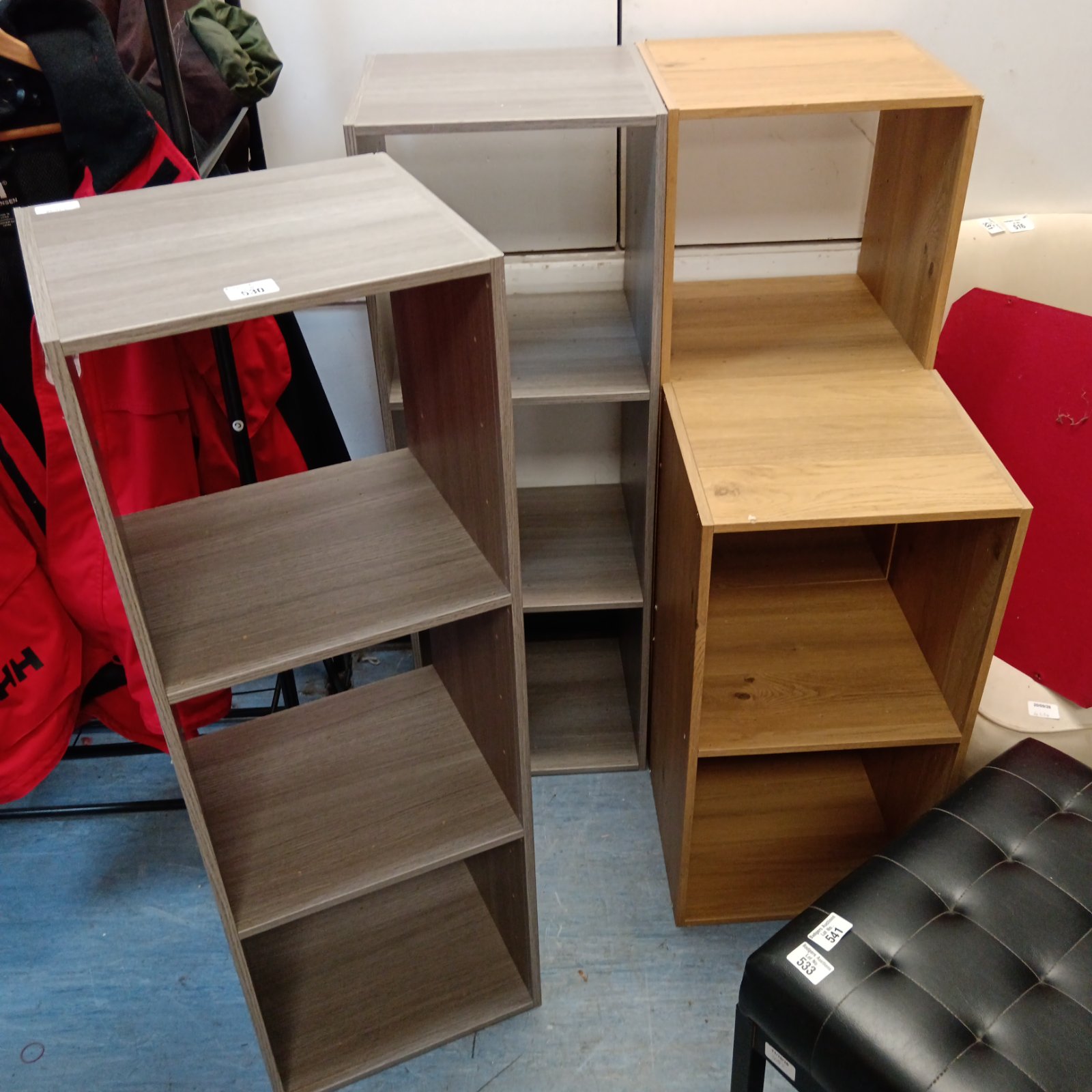 Four grey and pine effect cube storage units for home organisation.