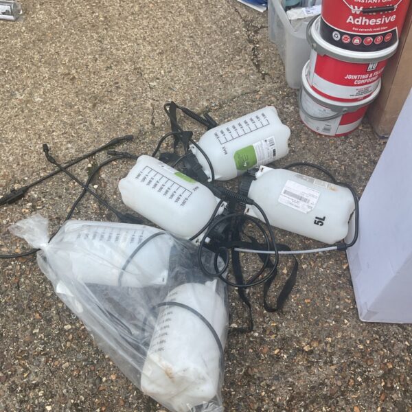 Bundle of used hand sprayers for repair and garden work.