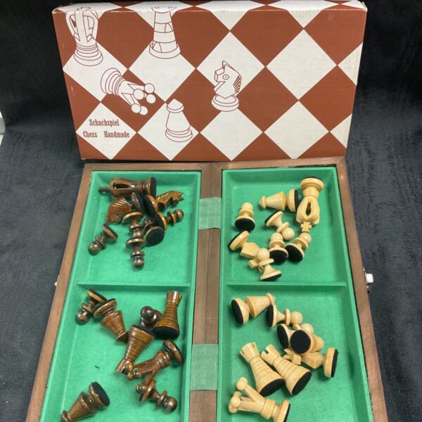 Handmade wood chess set with carved pieces on integrated board.