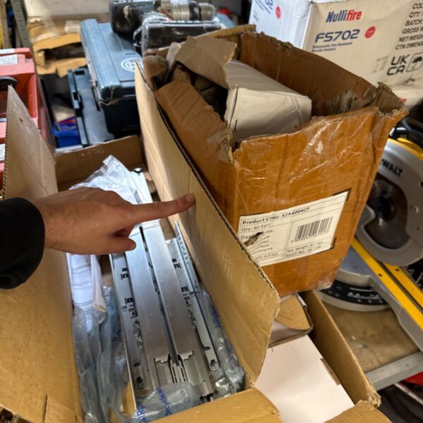 Box of chrome handrail brackets with a hand pointing to the label.