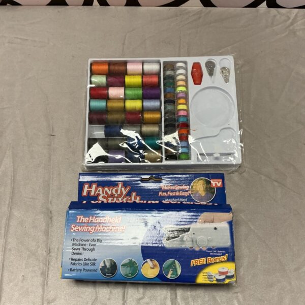 Handy Stitch handheld sewing machine box beside tray of coloured sewing thread