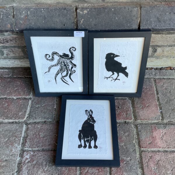 Set of three framed black ink wildlife artworks of an octopus, crow and hare