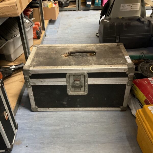 Heavy-duty flight case with a carry handle, showing signs of wear.
