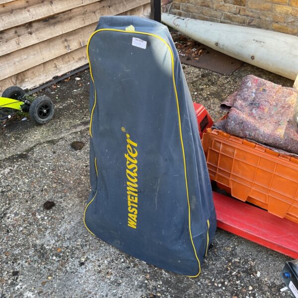 Hitchman Wastemaster towable garden waste collector in a garden setting.