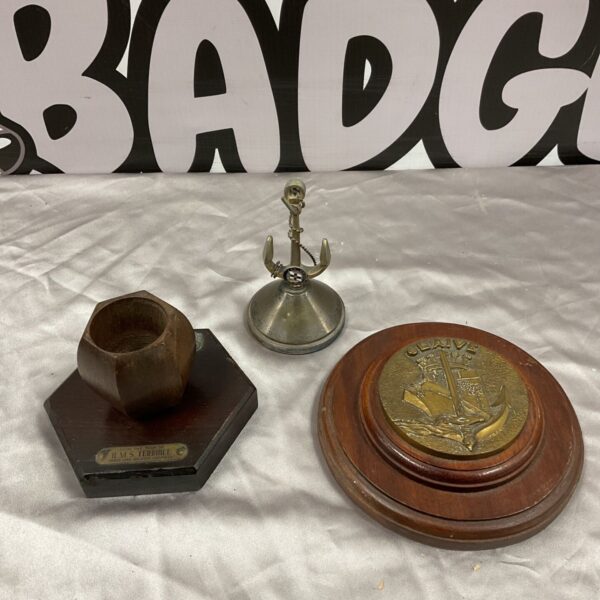 Wooden H.M.S. Terrible match pot, silver plate anchor paperweight and Glaive naval plaque