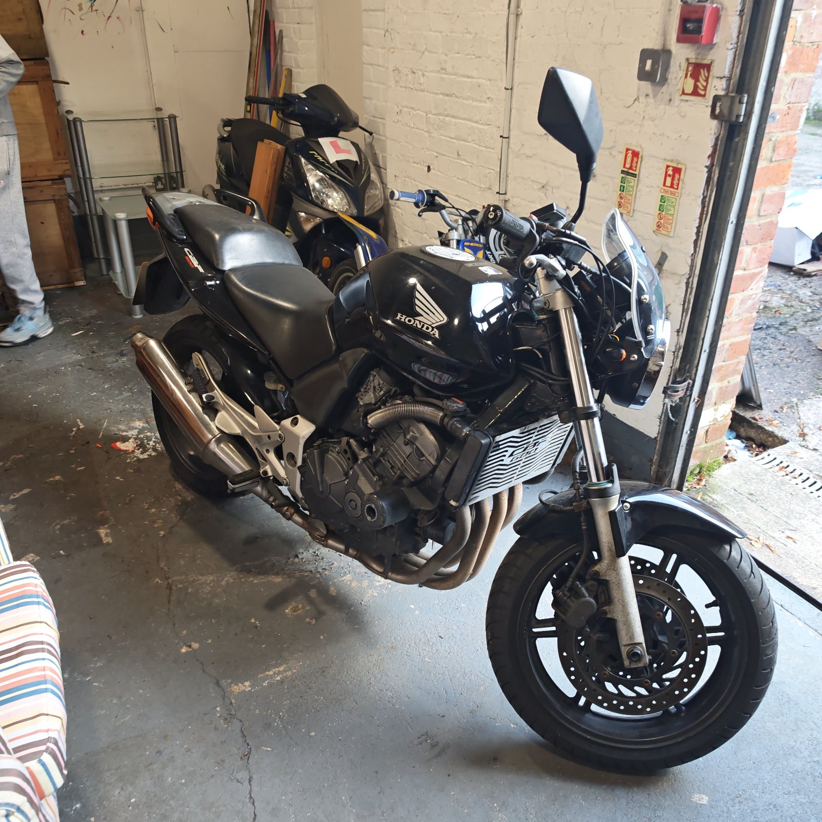 Black Honda CBF 600 motorcycle parked in workshop garage