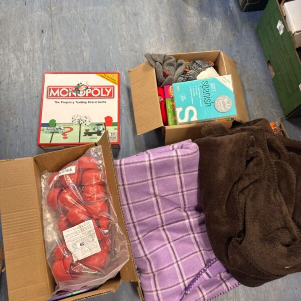 Mixed house clearance lot with Monopoly game and purple blanket.