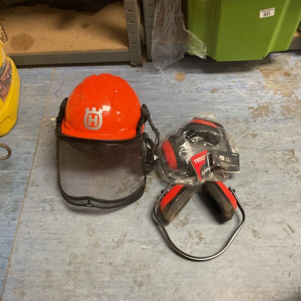 Orange Husqvarna forest helmet with metal visor beside Timco ear defenders