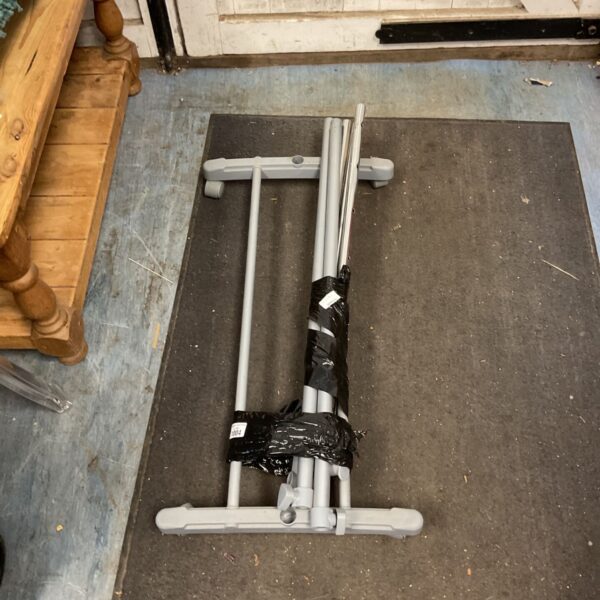 Disassembled Ikea clothing rack with metal tubing.