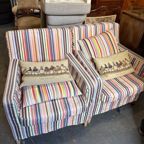 Pair of IKEA Karlstad armchairs with multicoloured striped upholstery and cushions