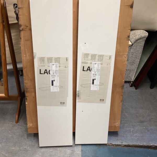 Pair of white IKEA LACK floating shelves in wrapped packaging
