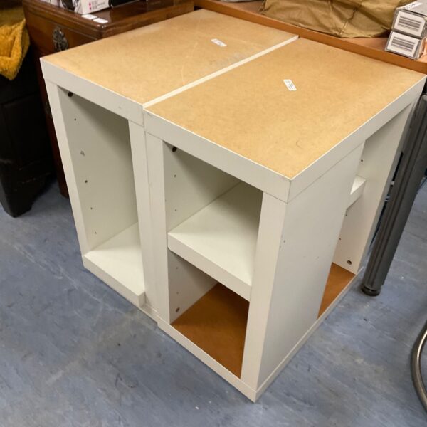 White Ikea shelf unit with cube storage compartments.