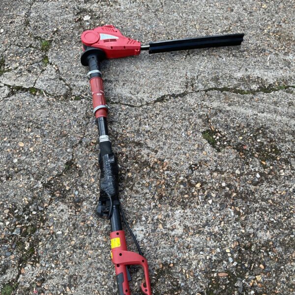 Used IKRA mogatec electric hedge trimmer for garden landscaping.