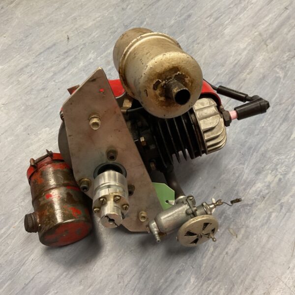 Vintage JAP model boat engine with fuel tank, side view.