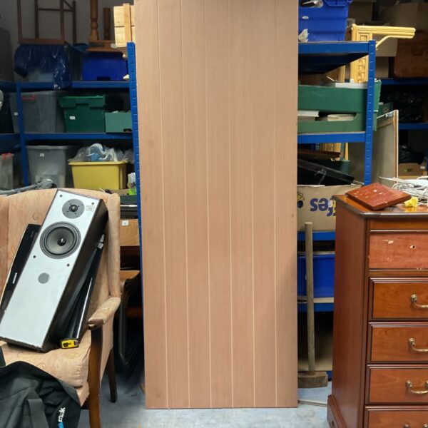Jeld-Wen 44mm fire door with pale wood-effect vertical panelled face