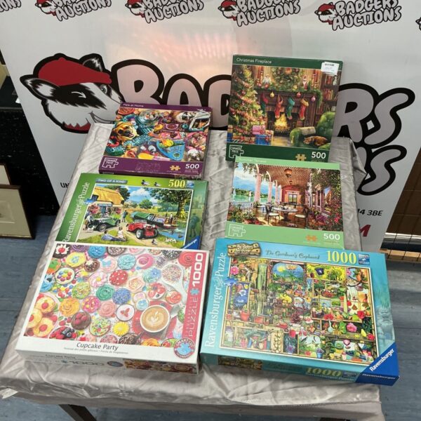 Six jigsaw puzzle boxes from Corner Piece, Ravensburger and Eurographics displayed together