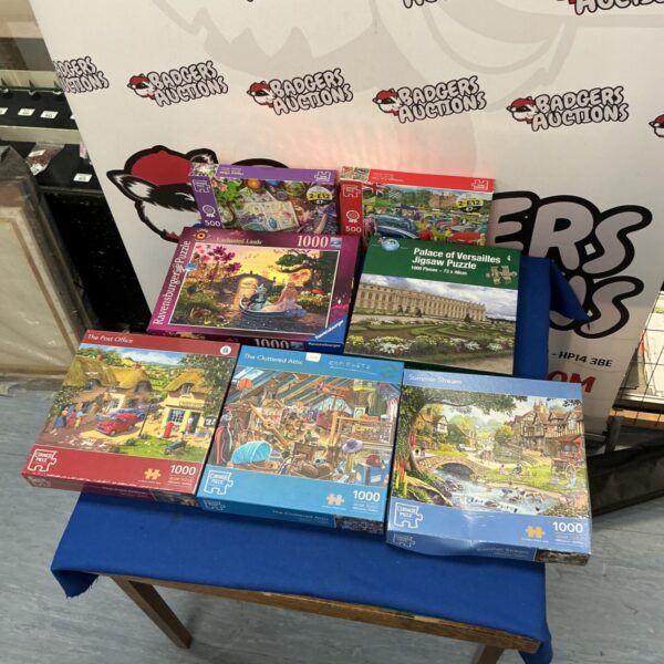Lot of assorted jigsaw puzzles including Ravensburger and Corner Piece.