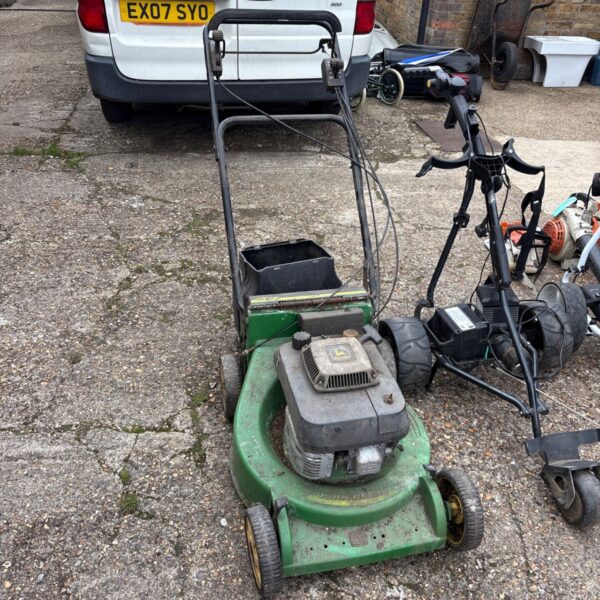 Used John Deere JX75 petrol lawn mower in a garden setting.