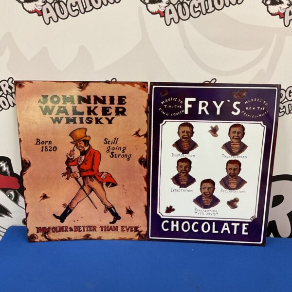 Johnnie Walker Whisky and Fry's Chocolate vintage-style advertising tin signs displayed together