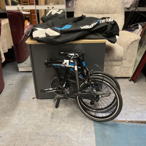 Black Kansi 3 Twenty folding bicycle shown folded beside its carry case