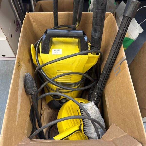 Karcher K3 pressure washer with attachments, ready for garden cleaning.