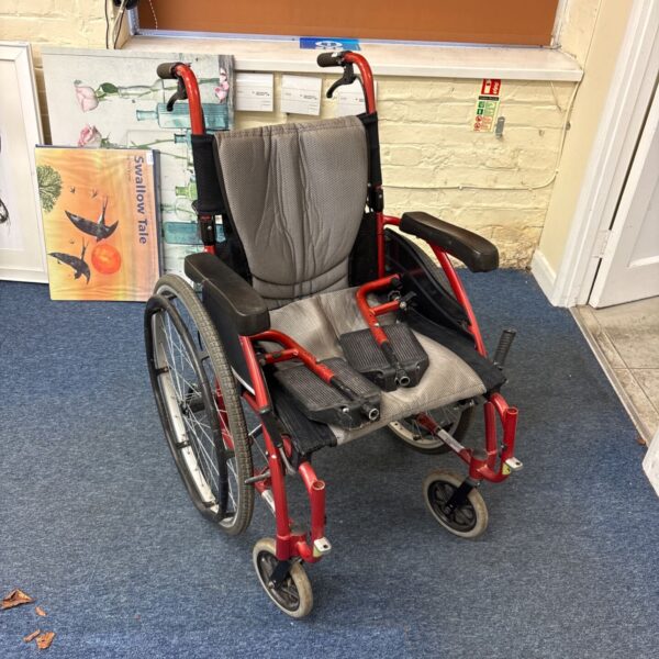 Red Karma S-Ergo 115 wheelchair with grey padded backrest and footrests