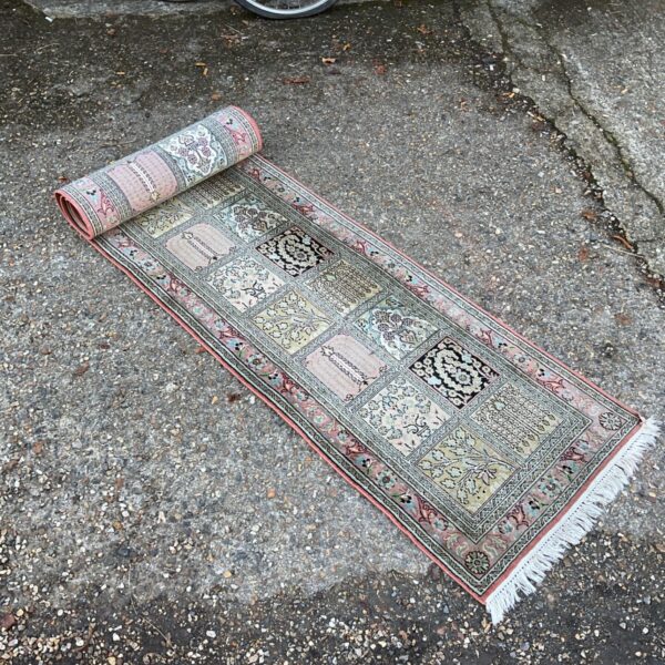 Intricate Kashmir runner rug with floral and medallion patchwork design.