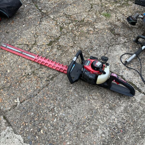 Used Kawasaki petrol hedge cutter for garden landscaping.