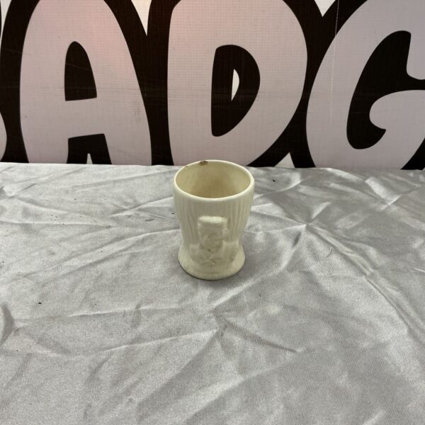 Cream glazed Keele St. Pottery Co Tonto egg cup with relief figure