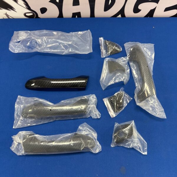 Carbon effect Kia door handle covers for vehicle interior styling.