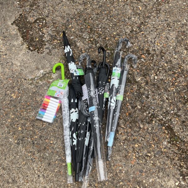Job lot of colourful kids umbrellas with character designs.