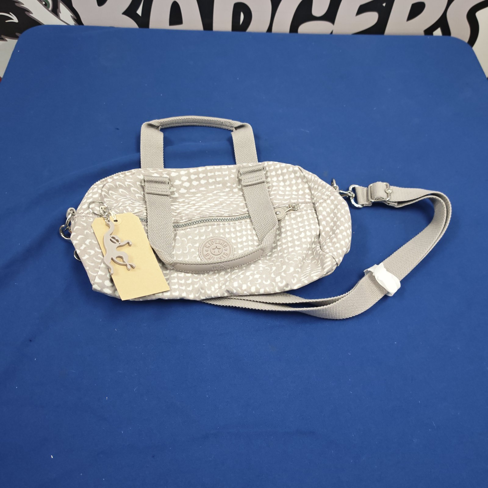 Kipling ladies handbag in grey and white patterned fabric with shoulder strap