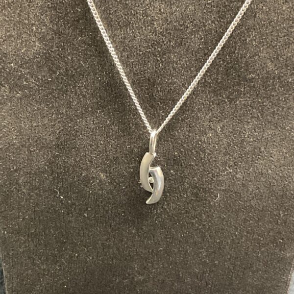 Kit Heath sterling silver pendant necklace with curved design.