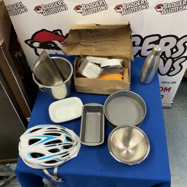 Assorted kitchenware lot including cake tins and bike helmet.