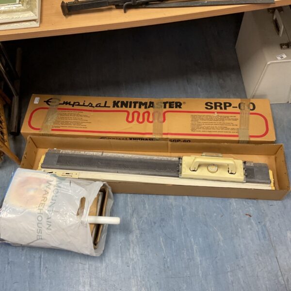 Vintage Knitmaster SRP60 knitting machine with accessories.