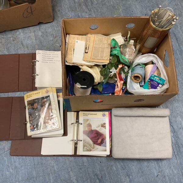 Mixed crafting lot with knitting pattern folders, needles, ribbon and haberdashery in a box