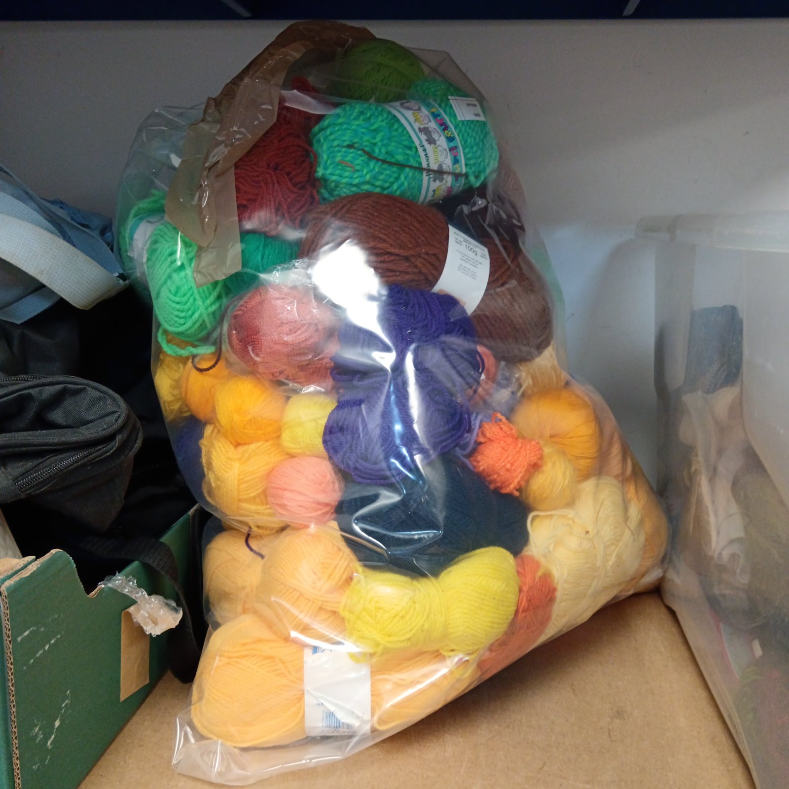 Large colourful lot of knitting wool for various craft projects.