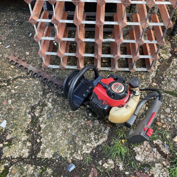 Kubota XT610 petrol hedge cutter with serrated blade and red engine