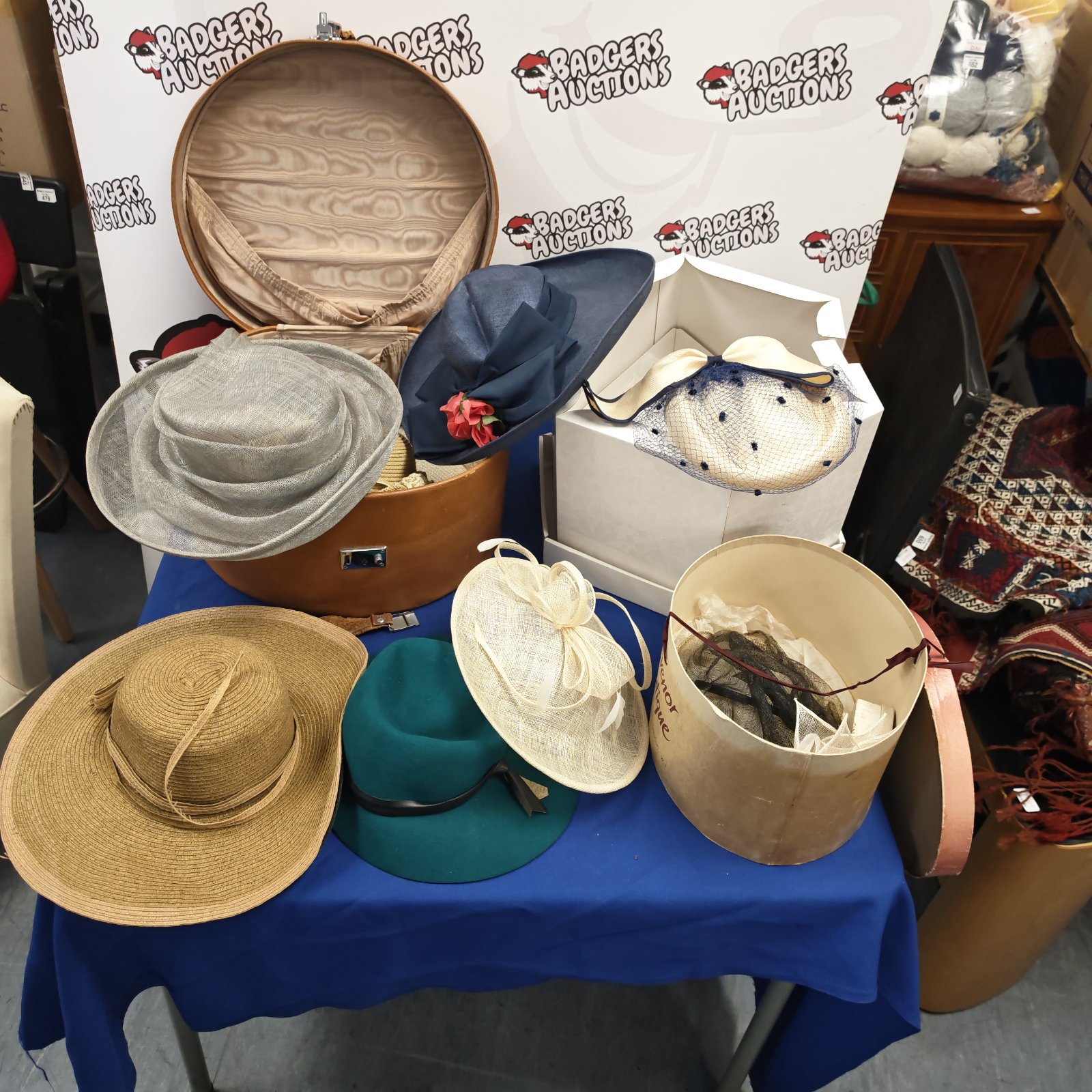 Bundle of ladies occasional hats with round hat boxes on a table