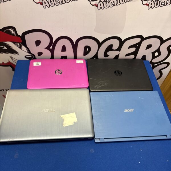 Front view of a bundle of four used laptops.
