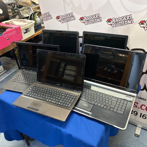 Mixed lot of used laptops including Toshiba, Lenovo, and Asus brands.