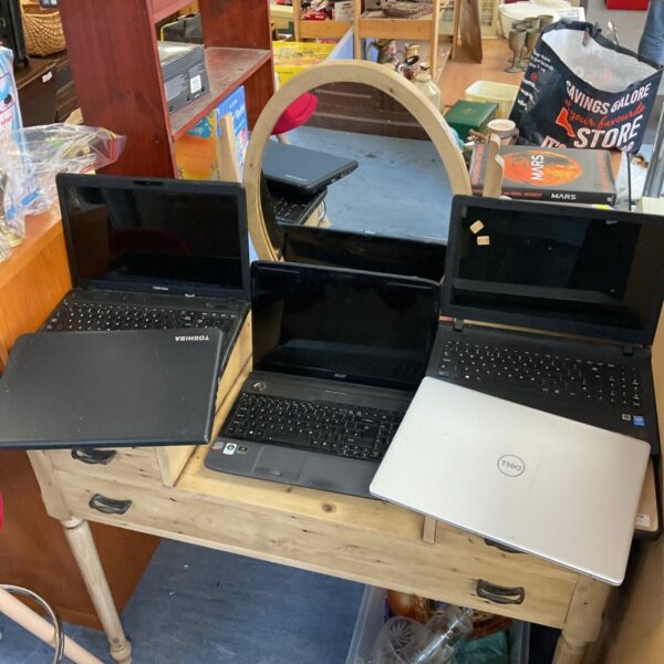 Toshiba, Acer and Dell laptops arranged on a pine desk