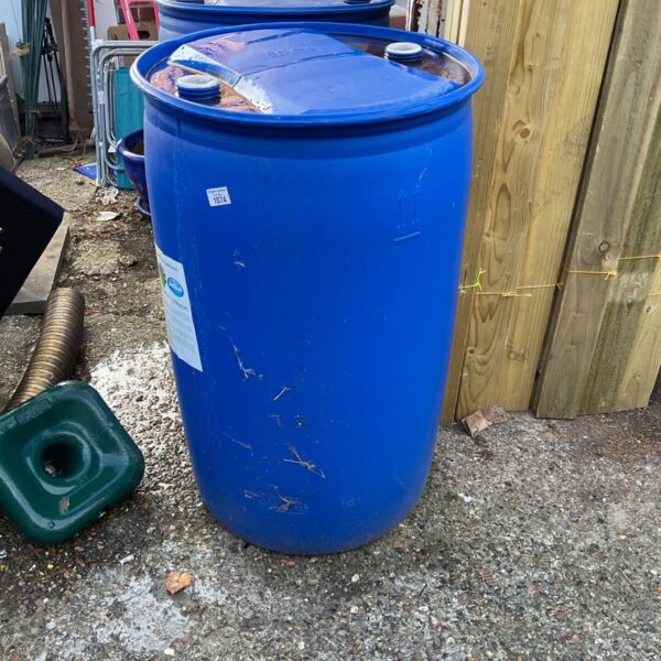 Large blue water butt for rainwater harvesting in a garden setting.