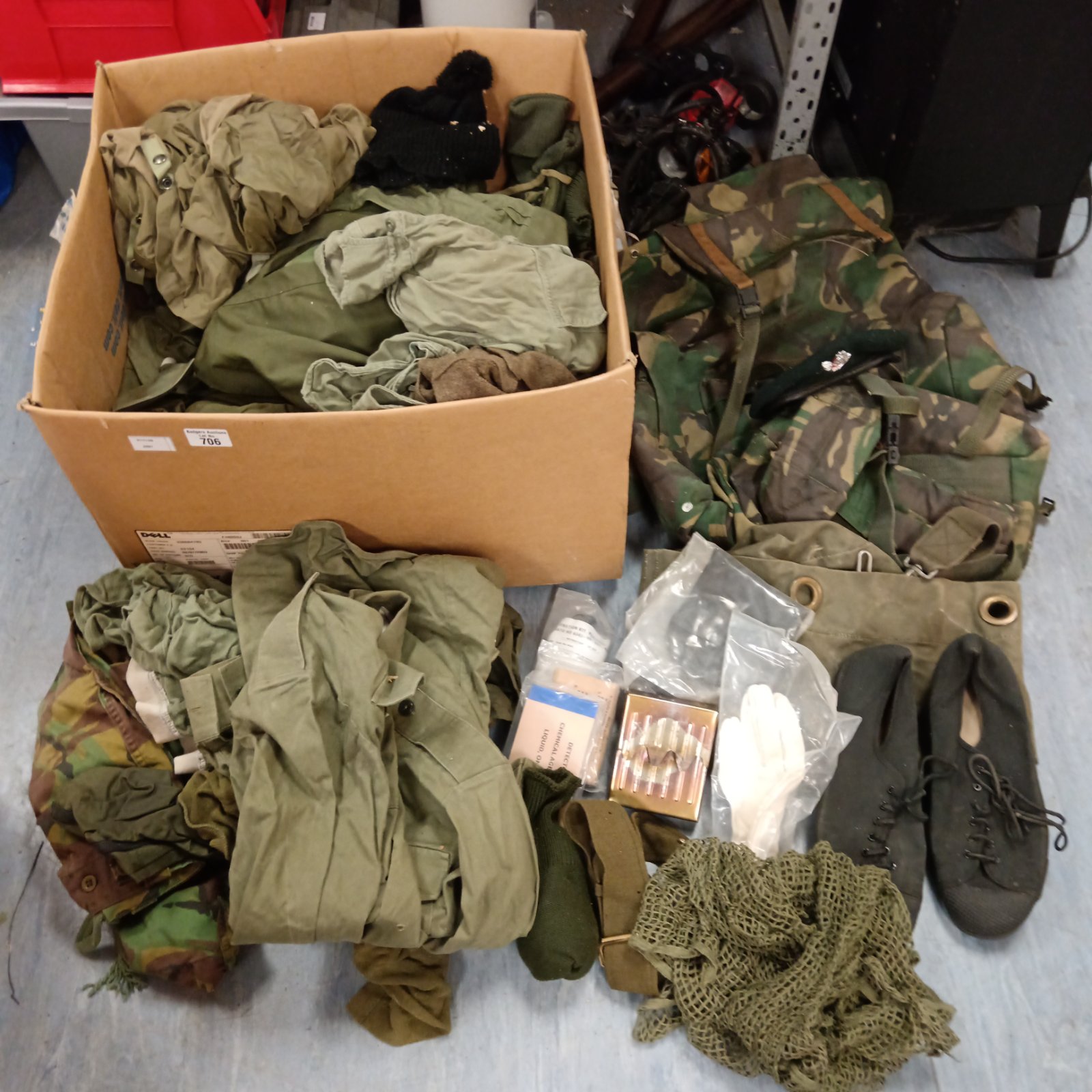 Large cardboard box of mixed military army clothing with camouflage and olive green garments